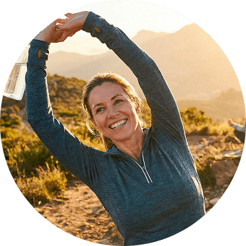 Woman stretching at sunrise