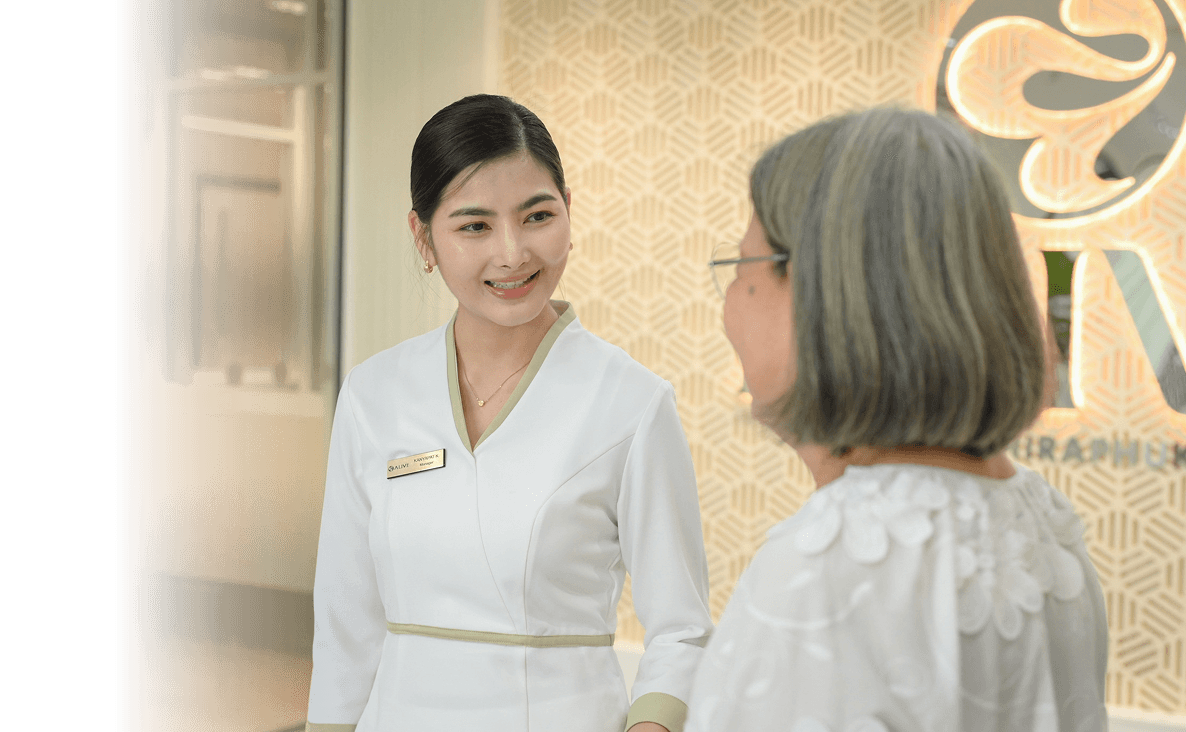 Two ALIVE clinicians in white coats smiling at one another